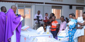 Children who were born prematurely receive a blessing during Mass led Fr. Surivenus Nungwa the Archdiocese of Mbarara Vicar General as Holy innocents children's hospital celebrates World Prematurity Day